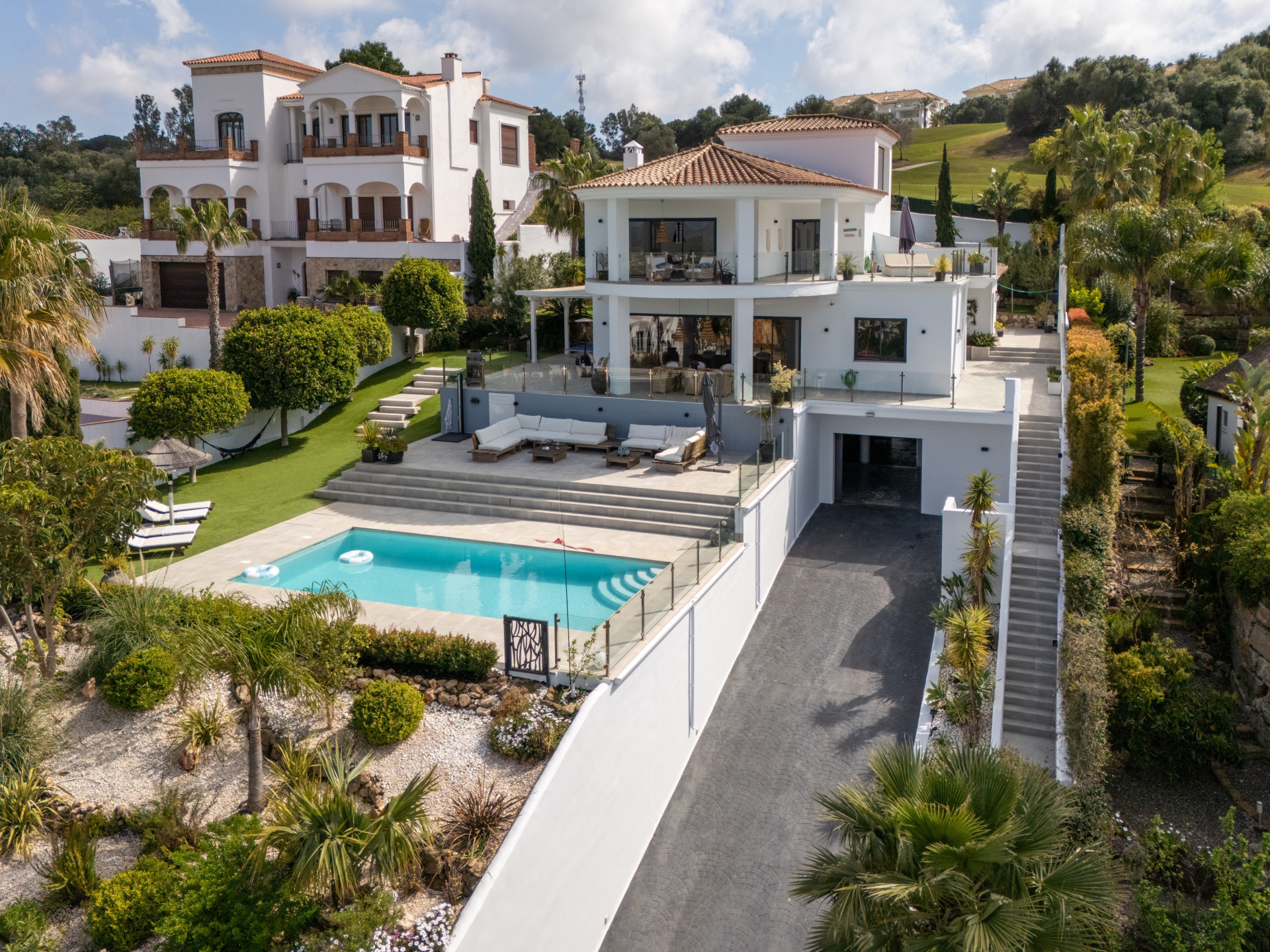 White villa above its private pool and driveway at La Cala Golf