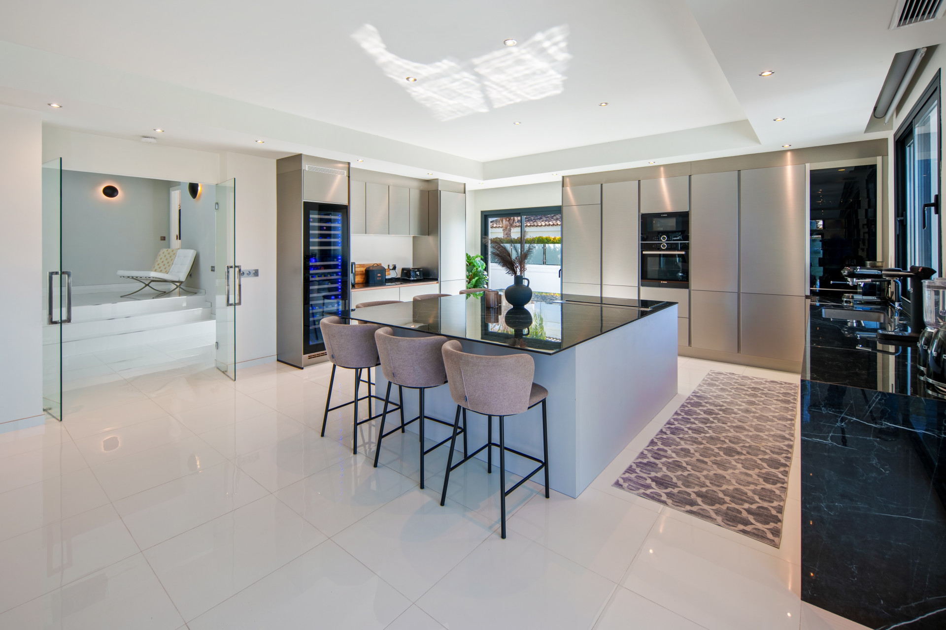Kitchen island with breakfast seating and fitted cabinetry