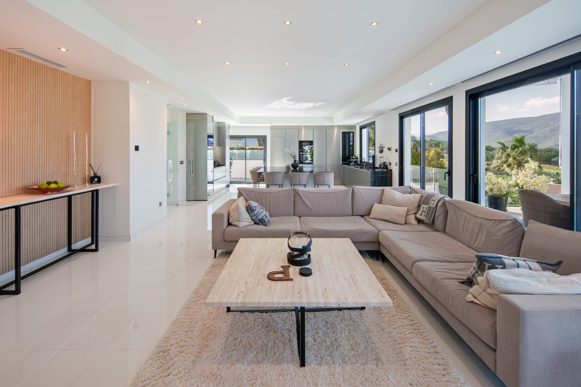 Open-plan lounge with wide sliding doors and mountain views