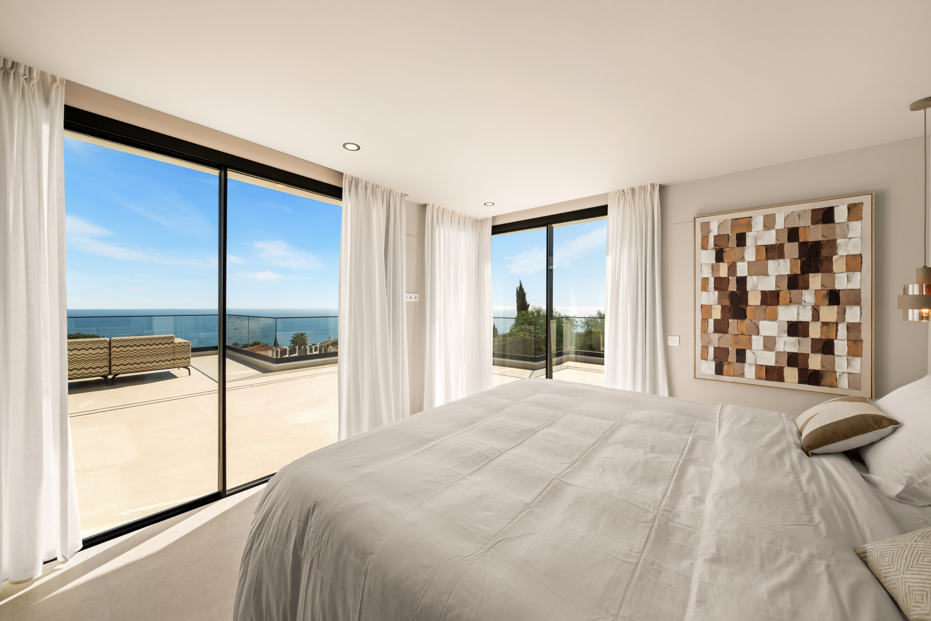 Bedroom opening onto a terrace overlooking the Mediterranean