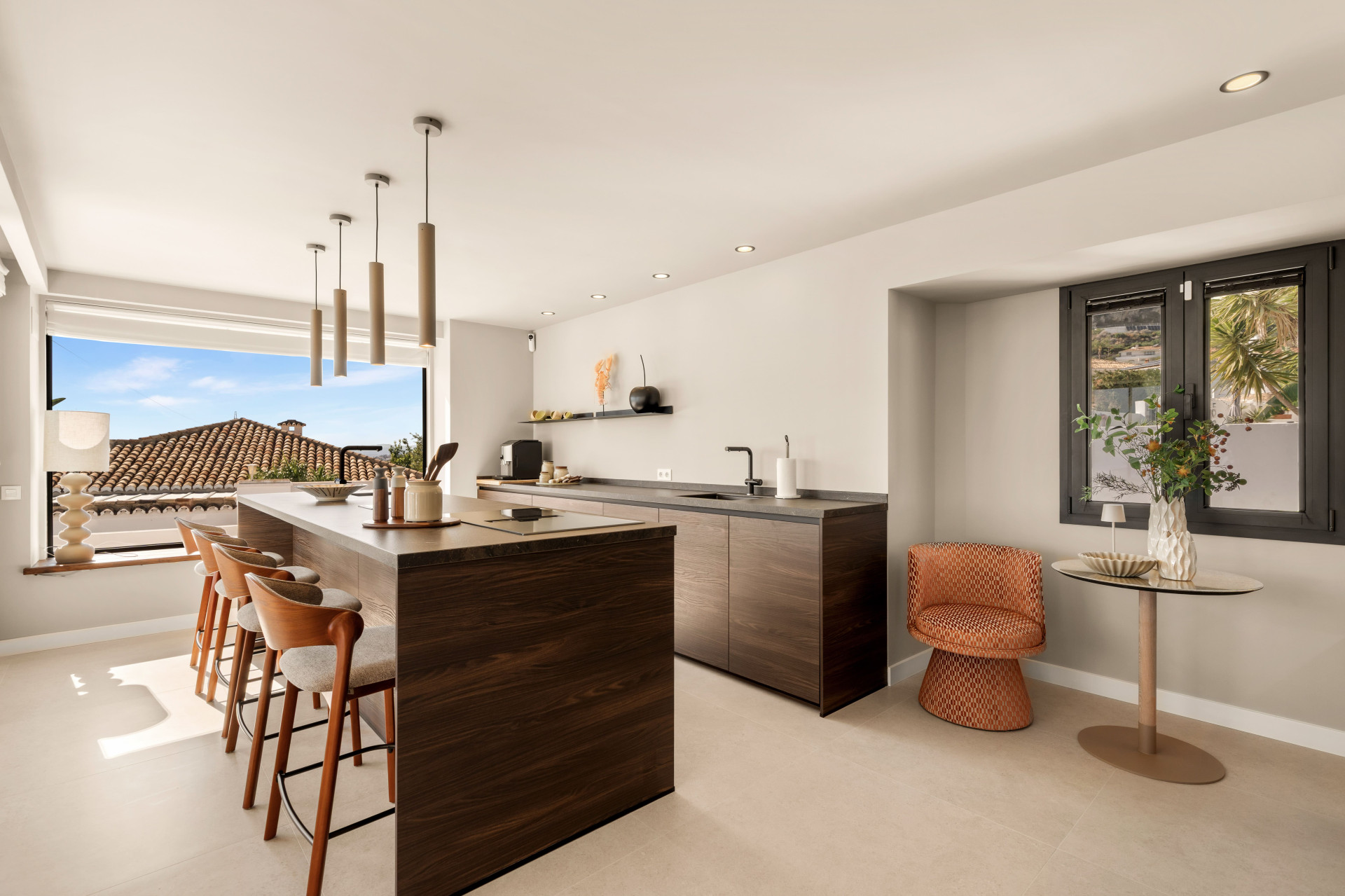 Wood-fronted kitchen island with breakfast seating and a sea outlook