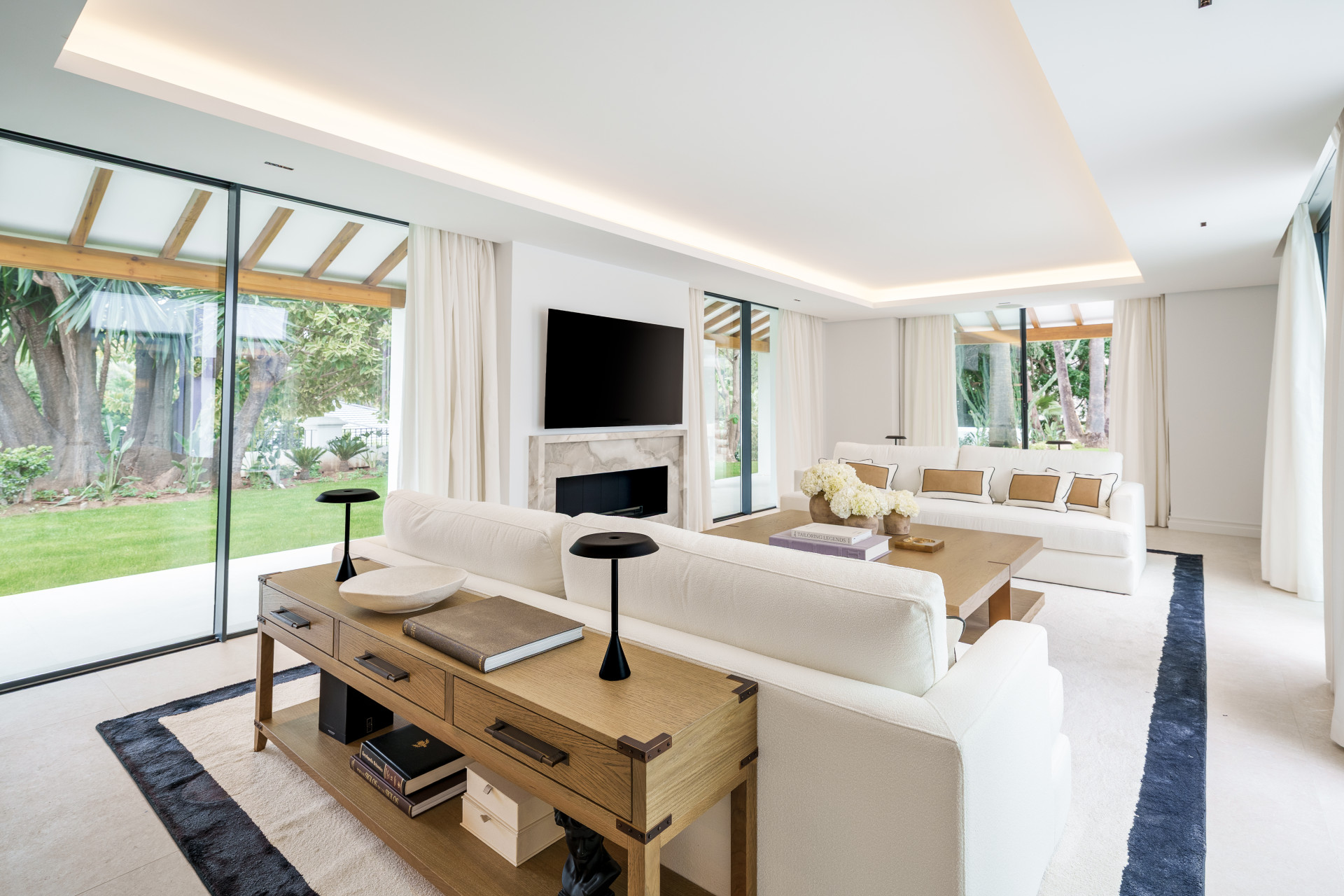 Bright living room with sliding glass doors opening to the villa garden
