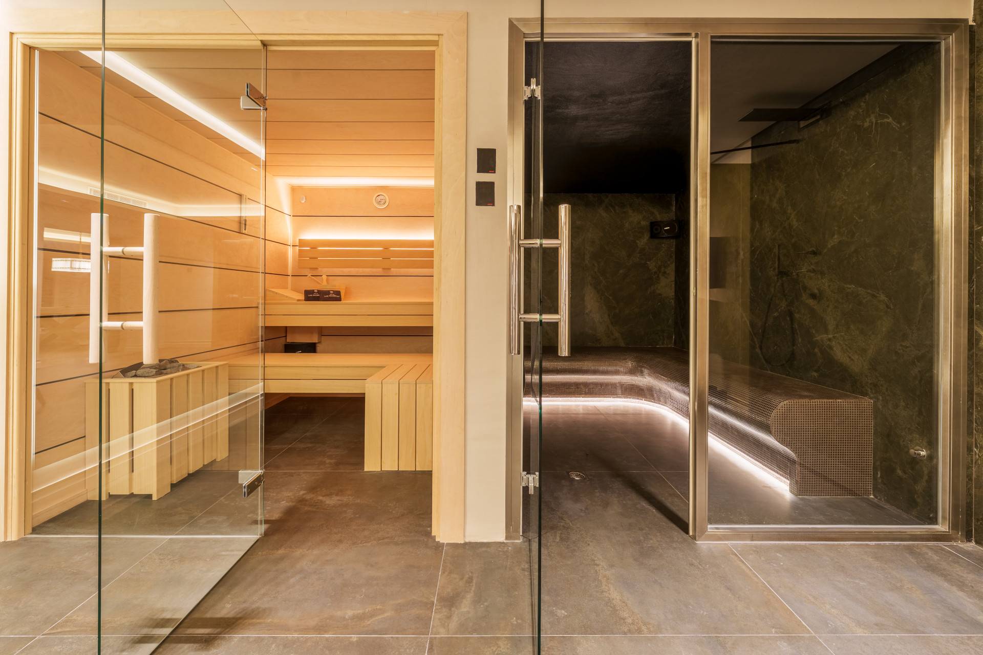 Glass-fronted sauna beside the villa's steam room