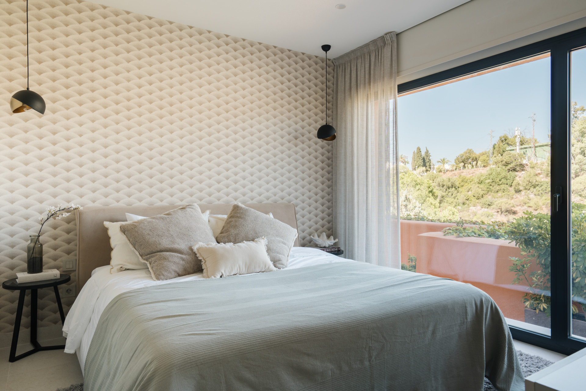 Bright guest bedroom opening onto a private terrace in the duplex penthouse