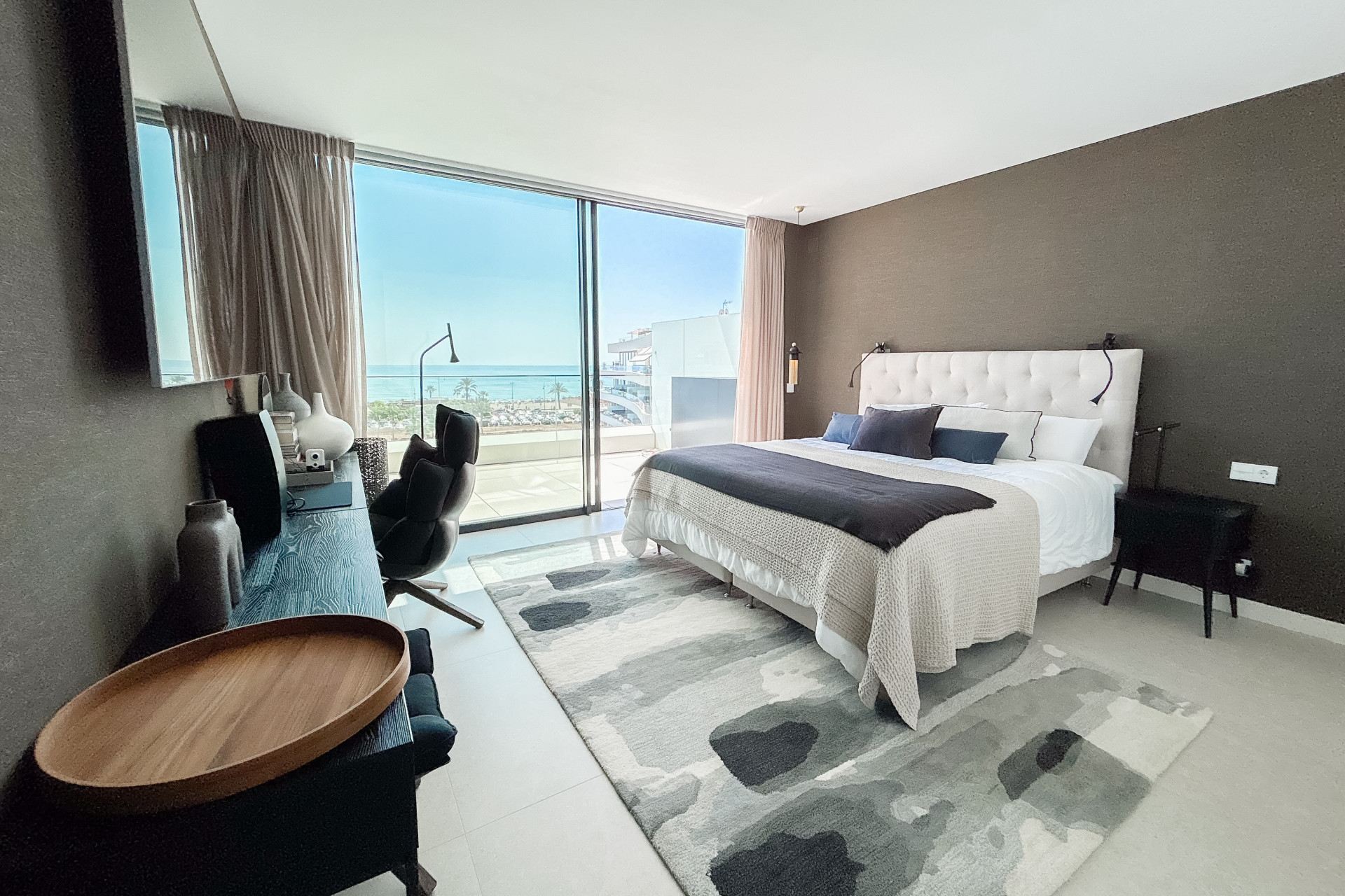 Principal bedroom with glazed terrace doors and views towards Los Álamos beach.