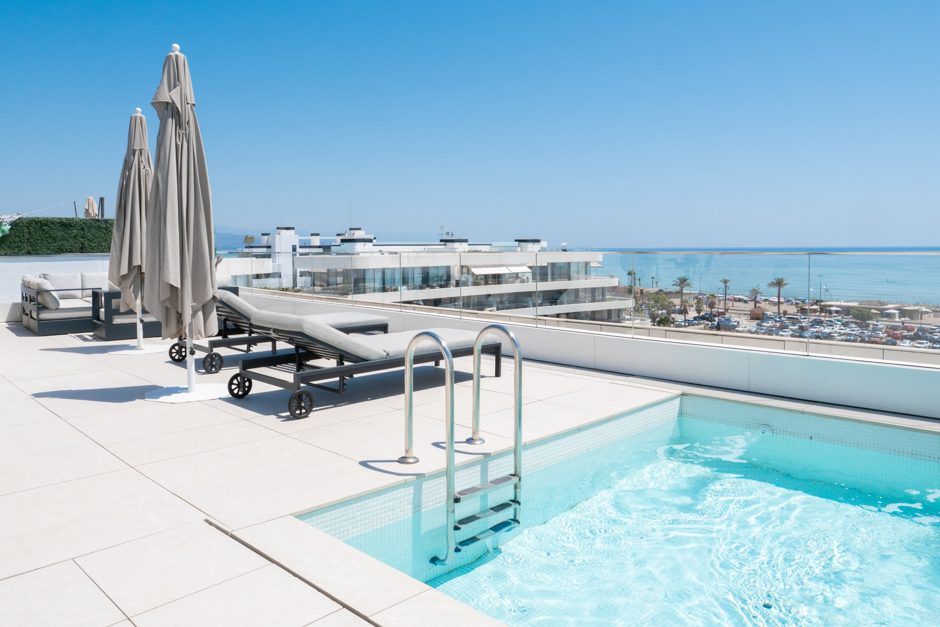 Private rooftop pool and sun loungers overlooking the sea at Nereidas, Torremolinos.