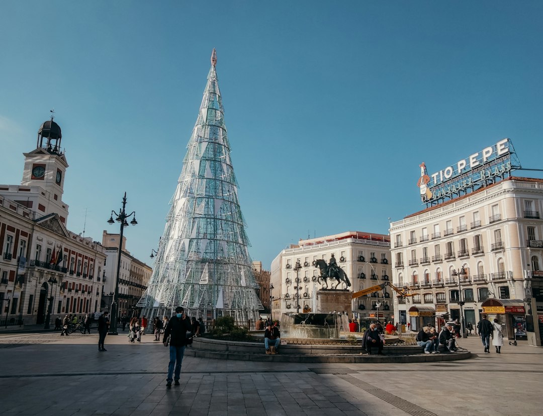 People walking beside historic architecture near Plaza de España in central Madrid