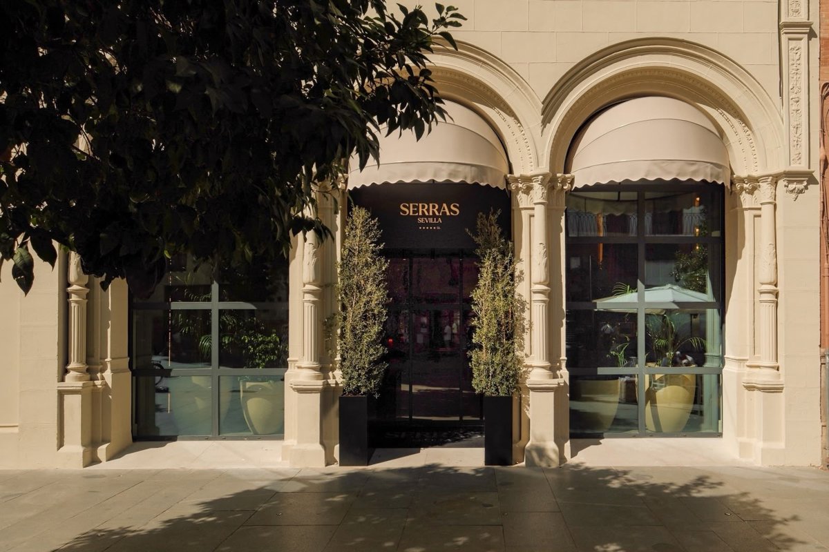 Arched entrance and pale stone facade of the newly opened Serras Sevilla hotel